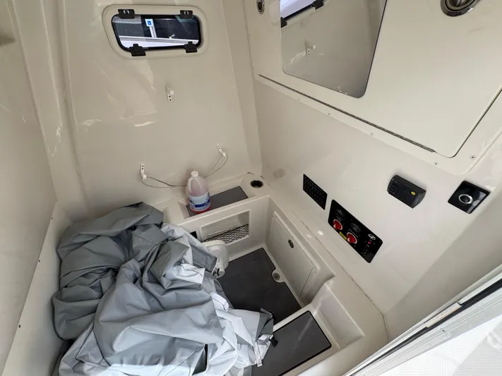  Yacht Photos Pics 2023 Sailfish 312 CC cabin interior with controls and storage.