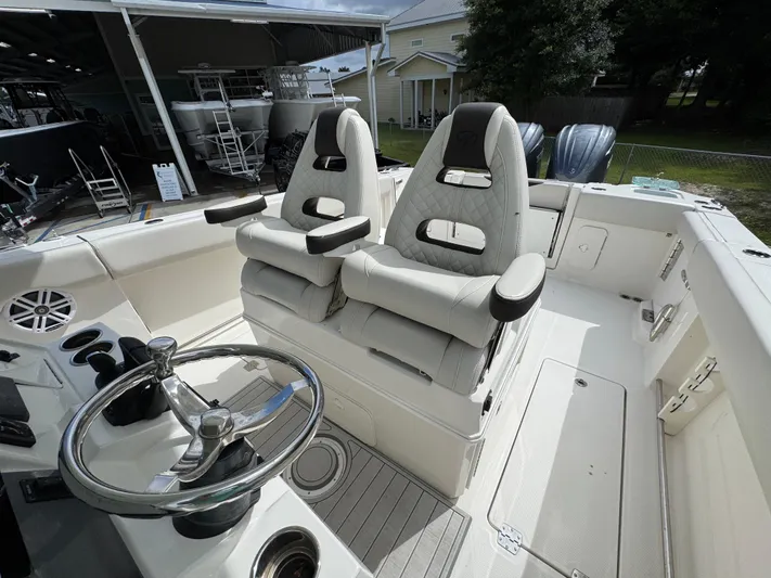  Yacht Photos Pics 2023 Sailfish 312 CC boat interior with dual captain's chairs and steering wheel.