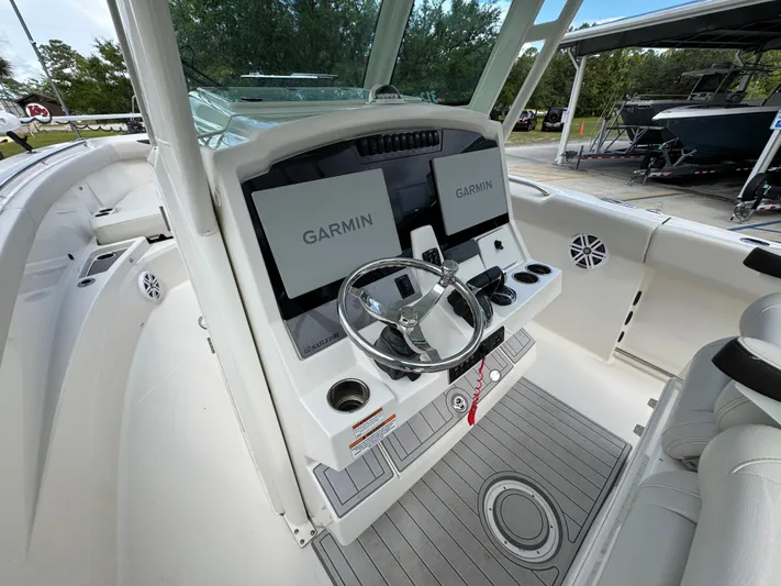  Yacht Photos Pics 2023 Sailfish 312 CC boat cockpit with dual Garmin displays and steering wheel.