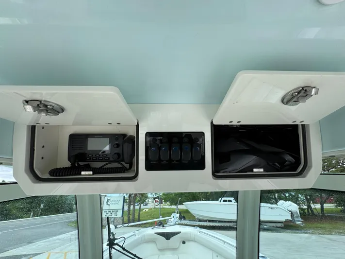  Yacht Photos Pics 2023 Sailfish 312 CC boat console with storage compartments and marine radio.