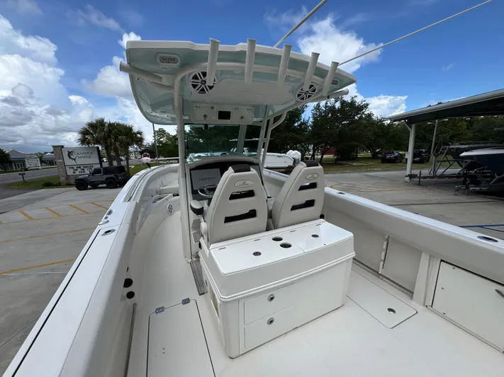  Yacht Photos Pics 2023 Sailfish 312 CC boat interior with dual seats and console, parked outdoors.