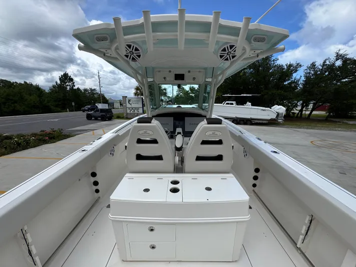  Yacht Photos Pics 2023 Sailfish 312 CC boat interior with helm and seating, parked outdoors.