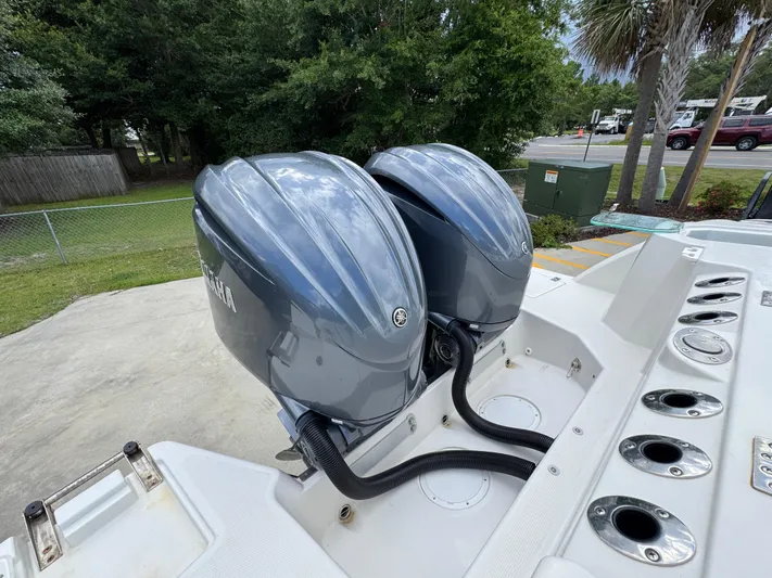  Yacht Photos Pics Twin Yamaha outboard engines on a 2023 Sailfish 312 CC boat, parked outdoors.