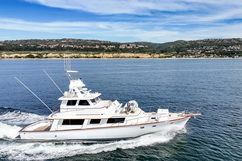Amakua Yacht Photos Pics 1970 Hargrave Yachtfisher cruising on open water with scenic coastal backdrop.