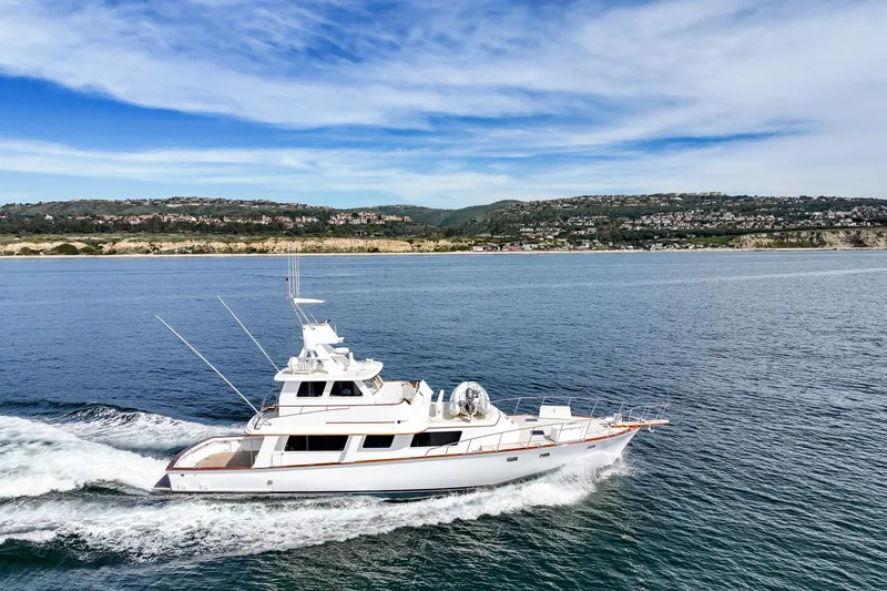Amakua Yacht Photos Pics 1970 Hargrave Yachtfisher cruising on open water with scenic coastal backdrop.
