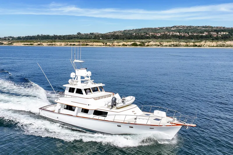 Amakua Yacht Photos Pics 1970 Hargrave Yachtfisher cruising on open water with scenic coastline backdrop.