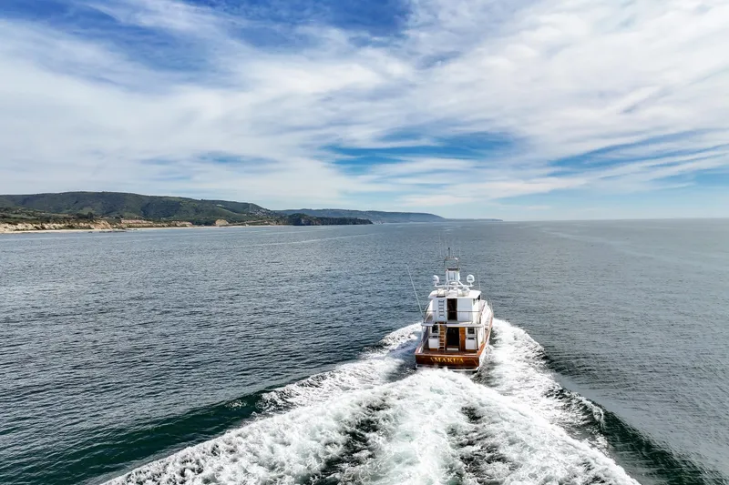 Amakua Yacht Photos Pics 1970 Hargrave Yachtfisher cruising on open sea under blue sky.