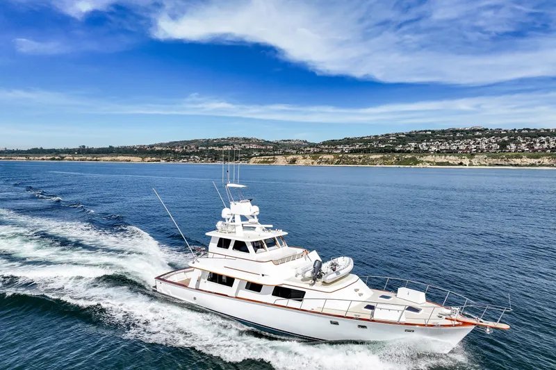 Amakua Yacht Photos Pics 1970 Hargrave Yachtfisher cruising on blue ocean near scenic coastline.