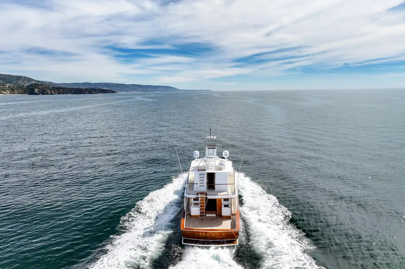 Amakua Yacht Photos Pics 1970 Hargrave Yachtfisher cruising on open sea under a partly cloudy sky.