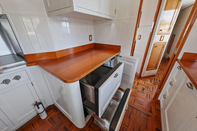 Amakua Yacht Photos Pics 1970 Hargrave Yachtfisher kitchen with wooden countertops and open drawers.