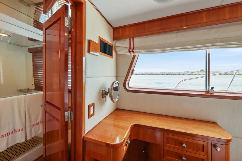 Amakua Yacht Photos Pics Interior of 1970 Hargrave Yachtfisher with wooden desk and ocean view window.