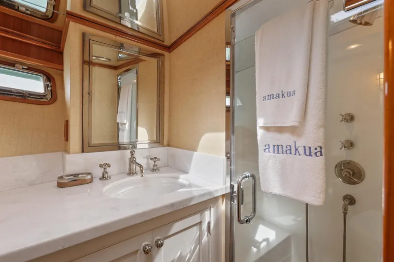 Amakua Yacht Photos Pics Luxurious bathroom on 1970 Hargrave Yachtfisher with elegant fixtures and mirrored cabinets.