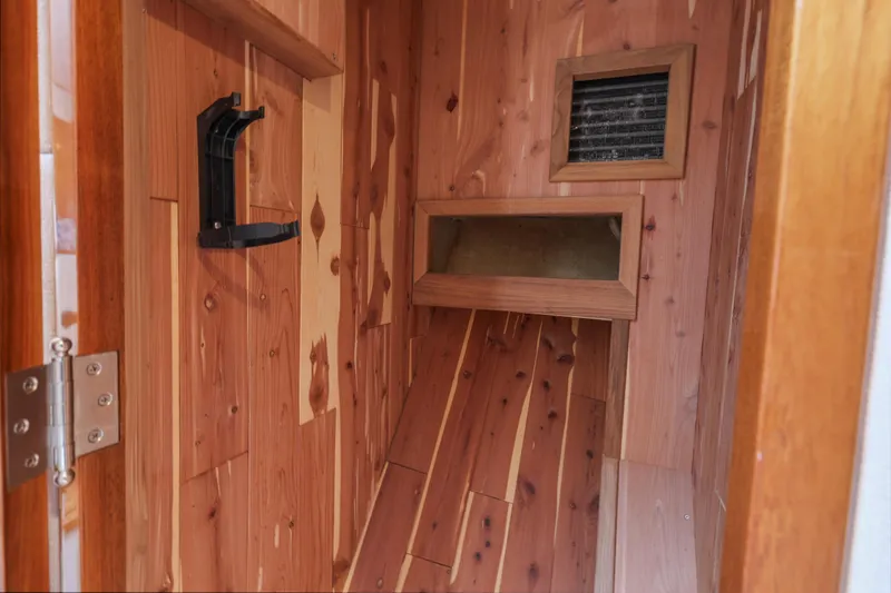 Amakua Yacht Photos Pics Wood-paneled interior of a 1970 Hargrave Yachtfisher, featuring a vent and storage space.