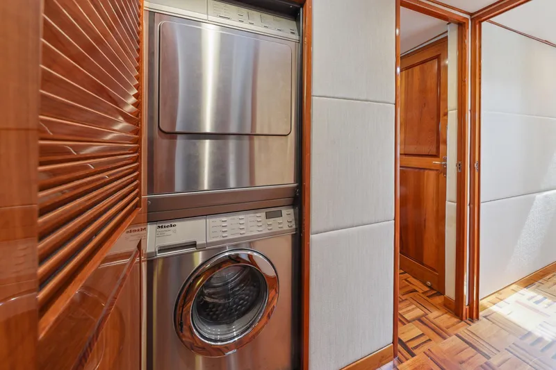 Amakua Yacht Photos Pics Stacked washer and dryer in 1970 Hargrave Yachtfisher interior with wood paneling.