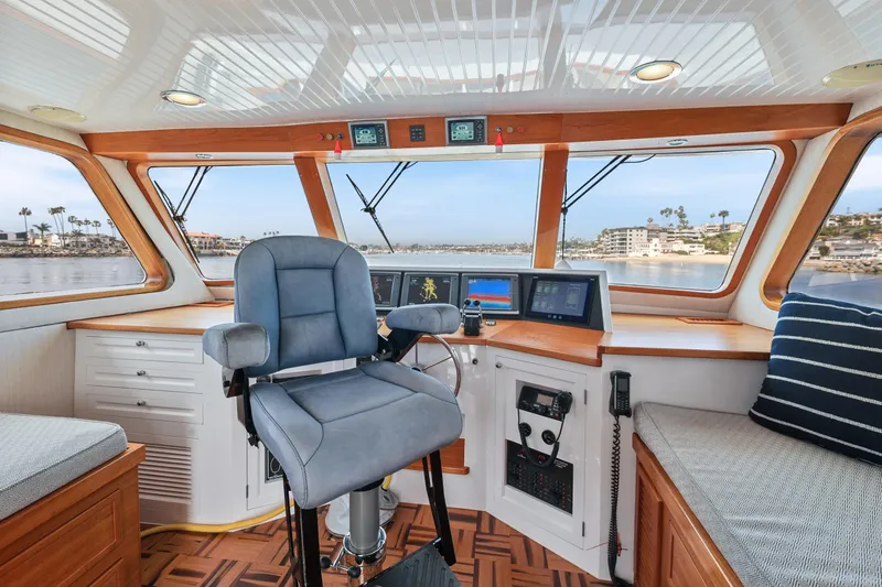 Amakua Yacht Photos Pics 1970 Hargrave Yachtfisher helm with modern controls, panoramic windows, and plush seating.