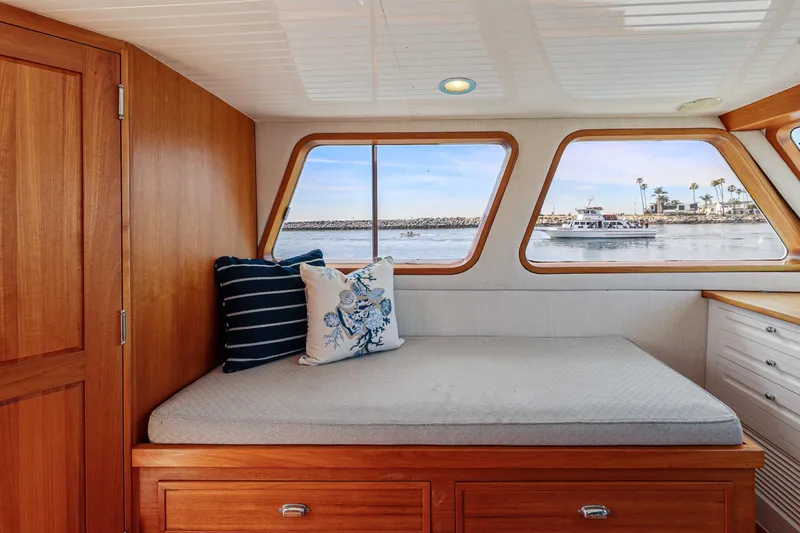 Amakua Yacht Photos Pics Cozy cabin interior of 1970 Hargrave Yachtfisher with scenic ocean view through windows.