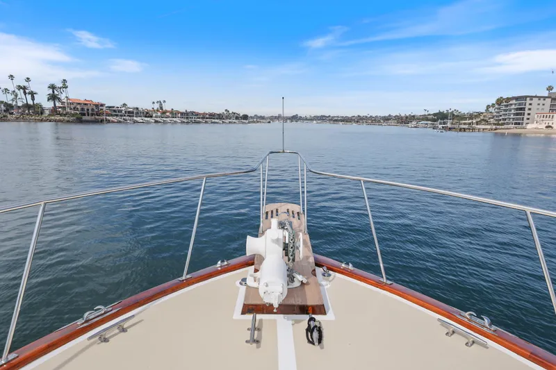 Amakua Yacht Photos Pics Bow view of 1970 Hargrave Yachtfisher cruising in a serene coastal harbor.