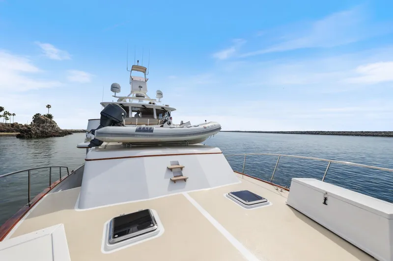 Amakua Yacht Photos Pics 1970 Hargrave Yachtfisher on calm waters with inflatable boat on deck.