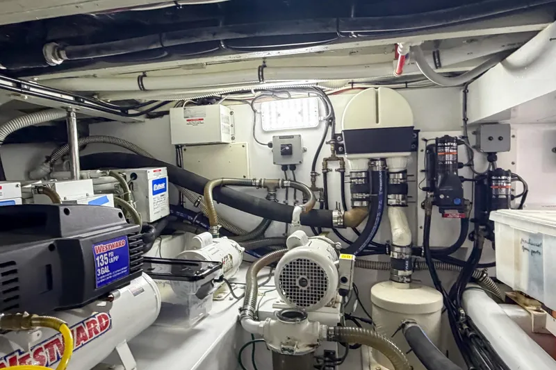 Amakua Yacht Photos Pics Engine room of a 1970 Hargrave Yachtfisher, showcasing mechanical equipment and piping systems.