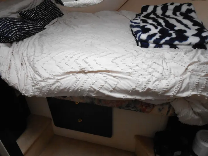 Fifty-150 Yacht Photos Pics Cozy bedroom interior of 1999 Silverton 352 MY yacht with patterned bedding.