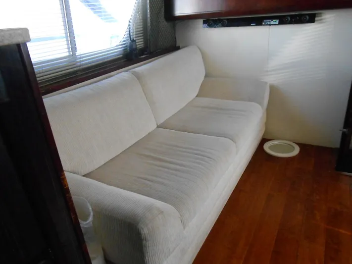 Fifty-150 Yacht Photos Pics Interior of 1999 Silverton 352 MY yacht with white sofa and wooden flooring.
