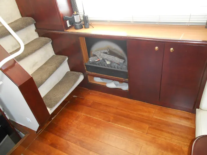 Fifty-150 Yacht Photos Pics Interior of 1999 Silverton 352 MY yacht with wooden flooring and carpeted stairs.