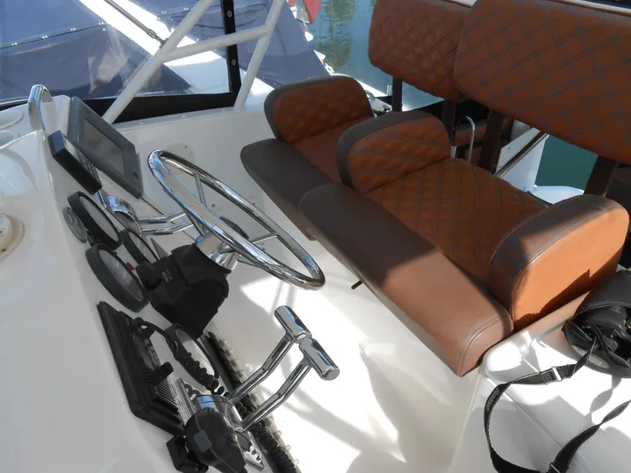 Fifty-150 Yacht Photos Pics 1999 Silverton 352 MY helm with brown leather seats and modern controls.