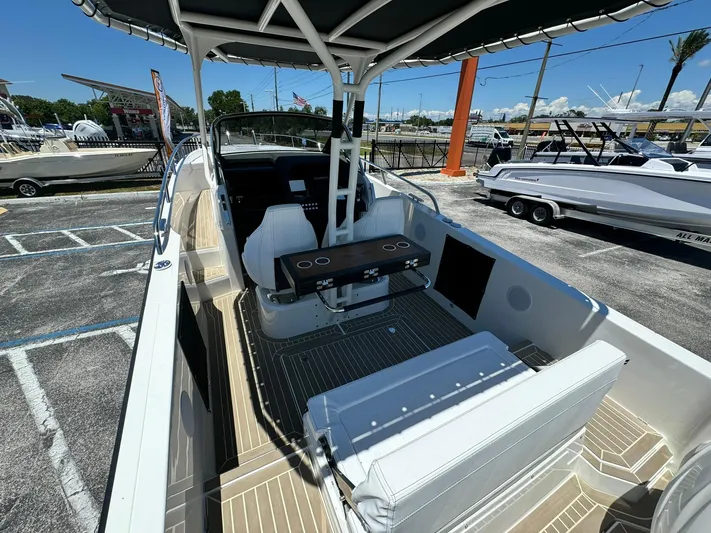  Yacht Photos Pics 2024 Windy SR28 CC boat interior with seating and table in a marina.