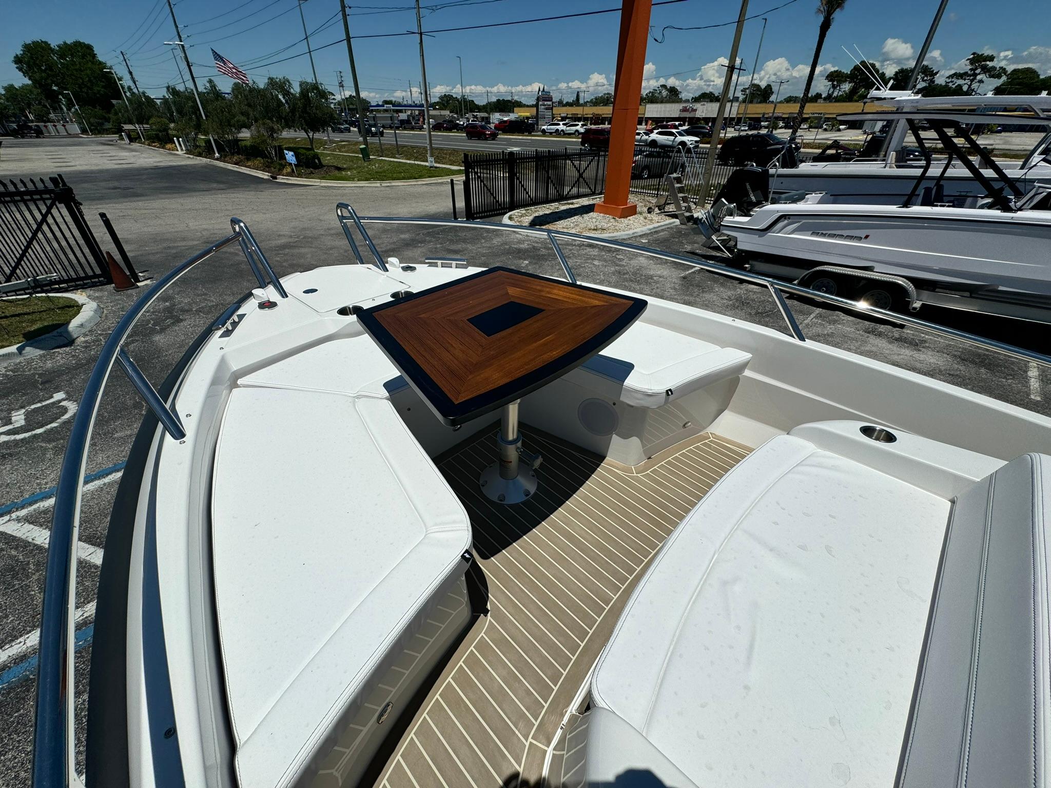 2024 Windy SR28 CC boat with white seating and wooden table in the bow.