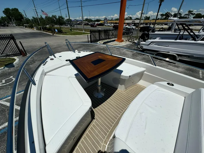  Yacht Photos Pics 2024 Windy SR28 CC boat with white seating and wooden table in the bow.