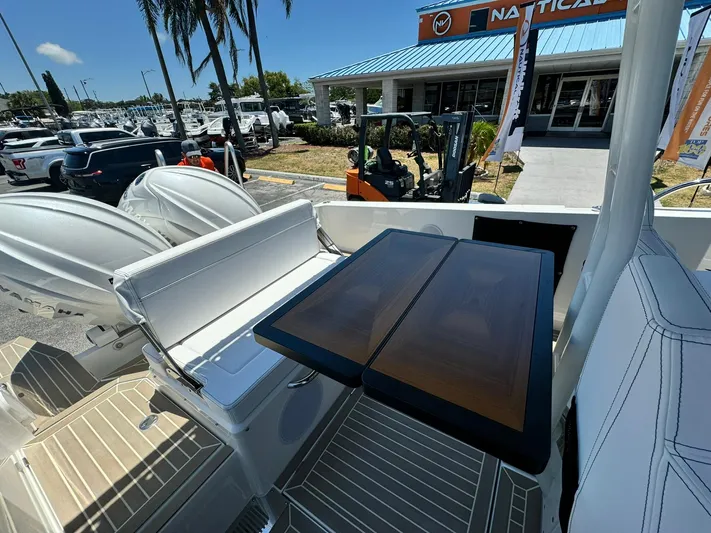  Yacht Photos Pics 2024 Windy SR28 CC boat with seating and table, docked at a marina.