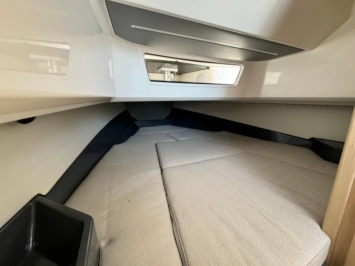  Yacht Photos Pics Interior cabin of 2024 Windy SR28 CC boat with cushioned sleeping area.