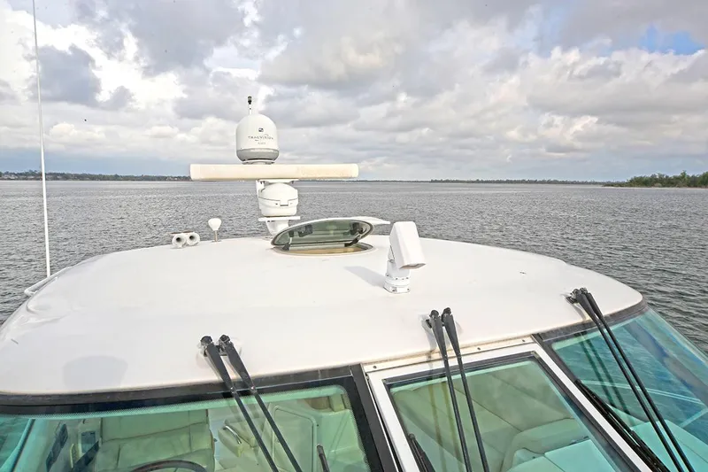 Ciao Bella Yacht Photos Pics 2007 Tiara Yachts 3900 Sovran on calm waters under cloudy sky.