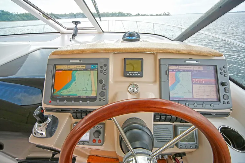 Ciao Bella Yacht Photos Pics 2007 Tiara Yachts 3900 Sovran helm with navigation screens and wooden steering wheel.