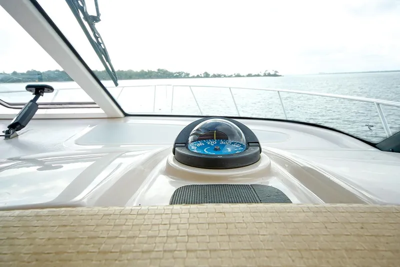 Ciao Bella Yacht Photos Pics 2007 Tiara Yachts 3900 Sovran helm with compass, overlooking serene waters.