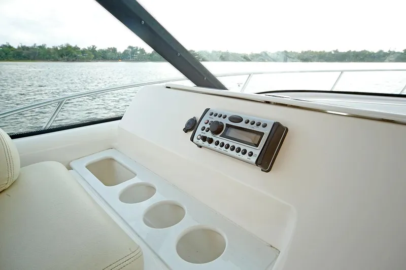 Ciao Bella Yacht Photos Pics 2007 Tiara Yachts 3900 Sovran dashboard with radio and cup holders, overlooking water.