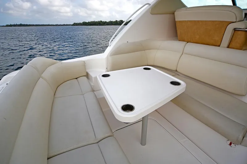 Ciao Bella Yacht Photos Pics 2007 Tiara Yachts 3900 Sovran interior with white seating and table, overlooking water.