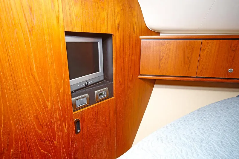 Ciao Bella Yacht Photos Pics 2007 Tiara Yachts 3900 Sovran cabin with built-in TV and wooden cabinetry.