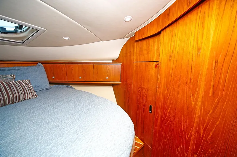 Ciao Bella Yacht Photos Pics Luxurious cabin interior of 2007 Tiara Yachts 3900 Sovran with wood paneling and cozy bedding.