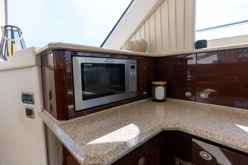 Aimee Yacht Photos Pics Luxurious kitchen area on 2008 Sea Ray 520 Sedan Bridge yacht with microwave and cabinets.