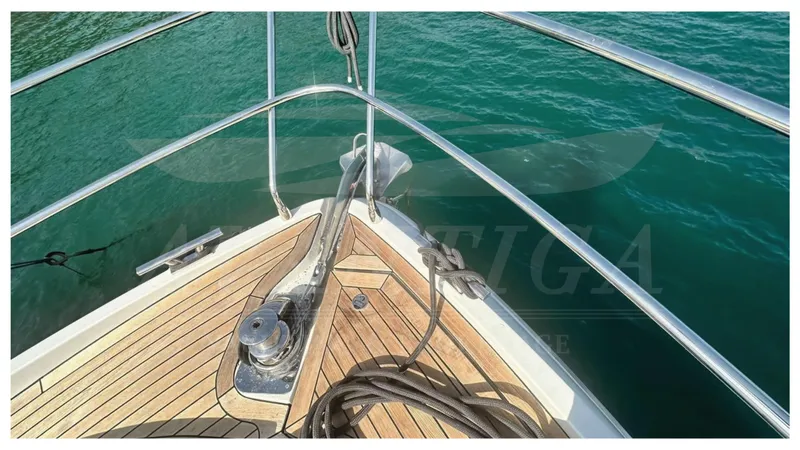  Yacht Photos Pics Bow of 2014 Absolute 52 FLY yacht with teak deck and anchor in clear water.