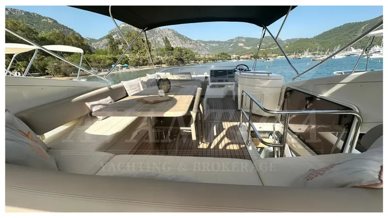  Yacht Photos Pics Luxurious 2014 Absolute 52 FLY yacht interior with seating and dining area, scenic ocean view.