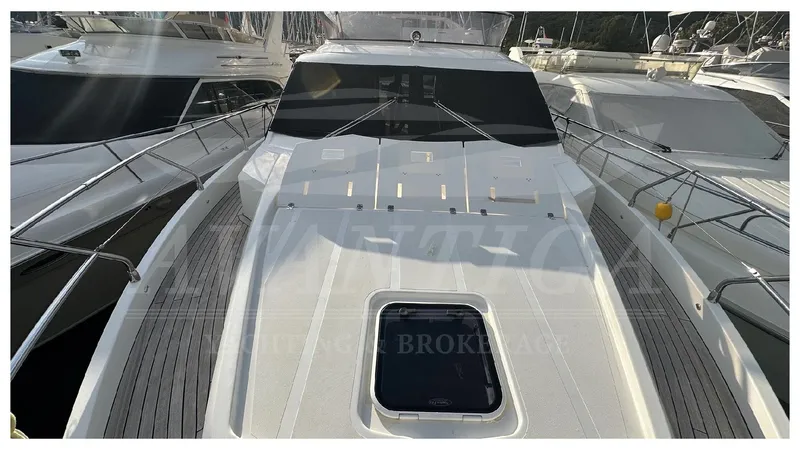  Yacht Photos Pics 2014 Absolute 52 FLY yacht, sleek design, docked among other boats.