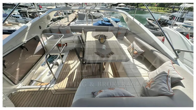  Yacht Photos Pics Luxurious 2014 Absolute 52 FLY yacht with elegant outdoor seating and dining area.