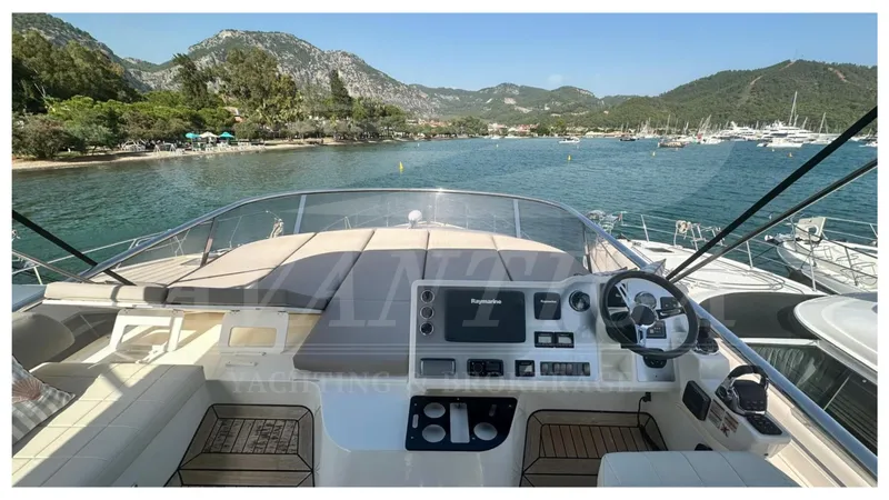  Yacht Photos Pics Flybridge view of 2014 Absolute 52 FLY yacht, overlooking serene coastal waters and lush hills.