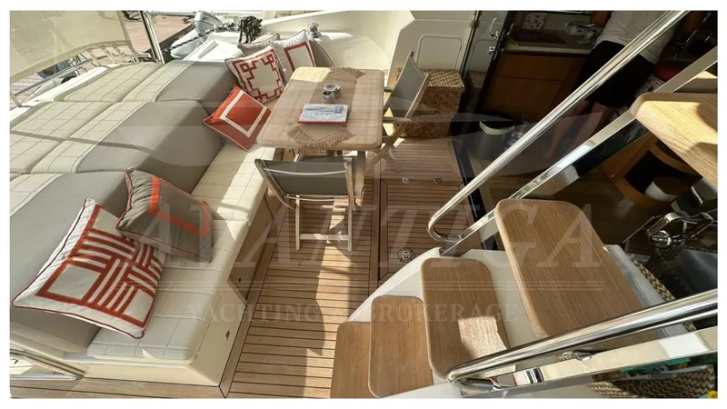  Yacht Photos Pics Luxurious interior of 2014 Absolute 52 FLY yacht with elegant seating and wooden accents.