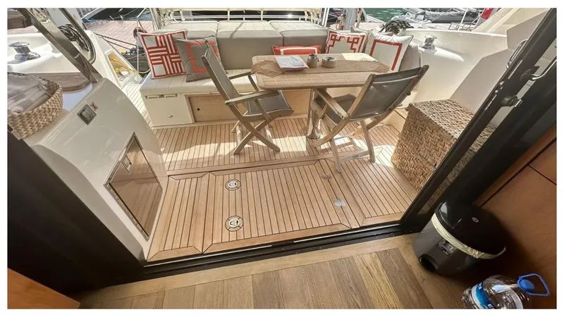  Yacht Photos Pics Luxurious 2014 Absolute 52 FLY yacht deck with seating, table, and stylish decor.