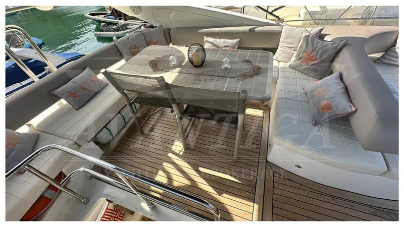  Yacht Photos Pics Luxurious seating area on a 2014 Absolute 52 FLY yacht with elegant cushions and table.
