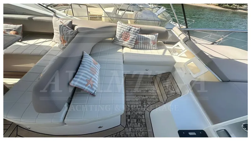  Yacht Photos Pics Luxurious seating area on 2014 Absolute 52 FLY yacht with cushions and wooden deck.