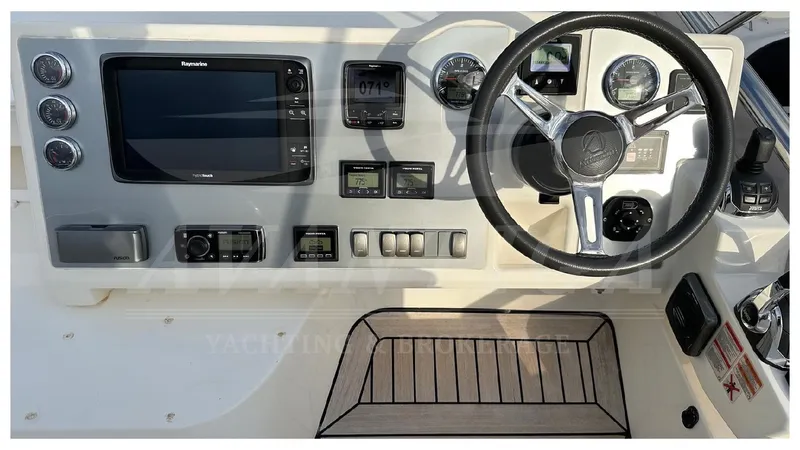  Yacht Photos Pics Cockpit of 2014 Absolute 52 FLY yacht with steering wheel and navigation controls.
